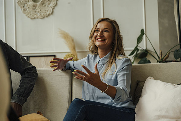 Woman smiling and speaking to her therapist, represents the connectedness and understanding one gets from the anxiety therapy in Castle Rock.