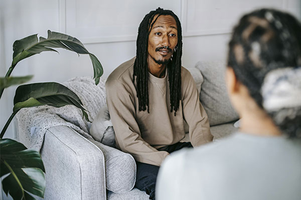 Man talking with his therapist about his emotions and traumatic experiences, during a EMDR therapy session in Castle Rock, CO.