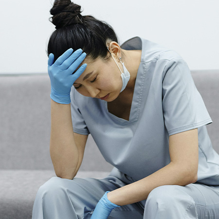 Tired nurse thinking of starting specialized therapy for health care workers at Authentic Connections in Castle Rock, CO.