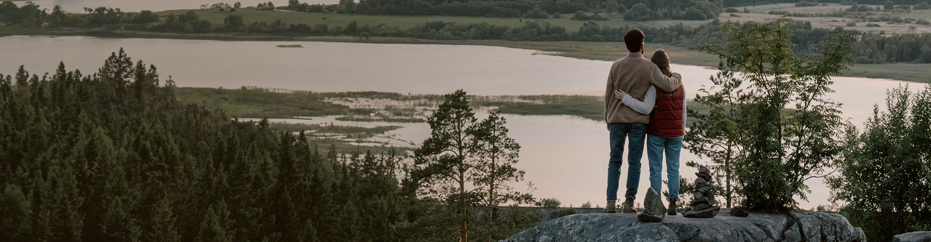 Couple hugging on a cliff, looking to reconnect and improve their relationship through marriage counseling in Castle Rock.