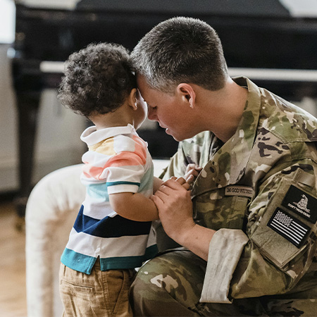 Female military soldier hugging her son, symbolizing the psychological support military families receive in Castle Rock.