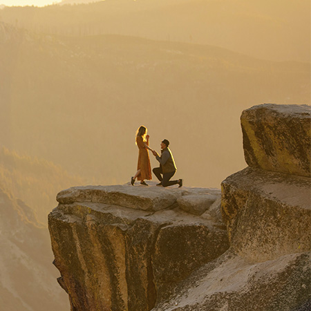 Man proposing to his partner in the mountains, symbolizing a happy future with pre-marital counseling in Castle Rock, CO.