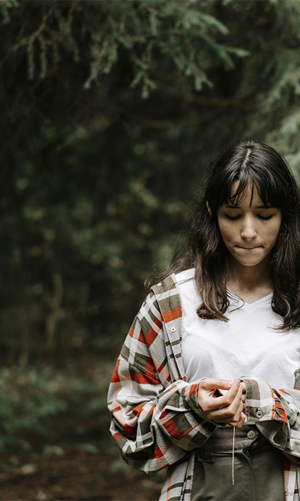 Contemplative teenage girl in forest, looking to start teen counseling with Authentic Connections in Castle Rock, CO.