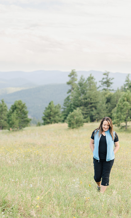 Authentic Connections founder, Dawn Gabriel, walking in a nature, representing the well-being offered by the therapy services in Caste Rock, CO.
