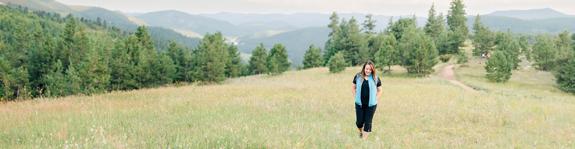 Authentic Connections founder, Dawn Gabriel, walking in a nature, representing the well-being offered by the therapy services in Caste Rock, CO.