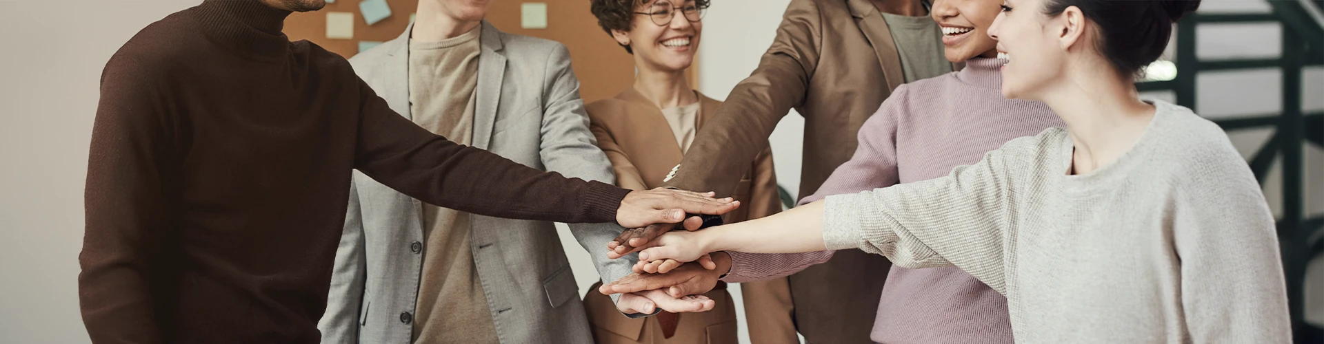 Group of people with their hands together, representing the connection and support you can experience from joining our Castle Rock Therapist Connection meet-ups.