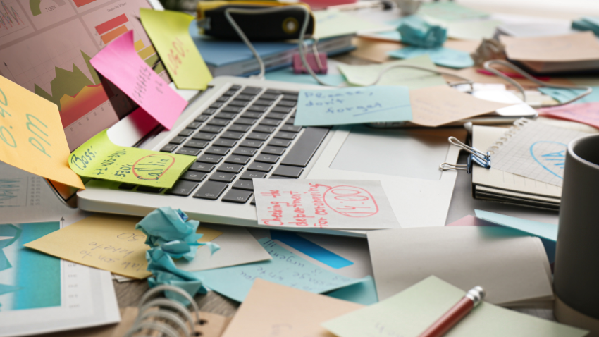 A cluttered desk representing the distractions and disorganization that can be and adult symptom of ADHD.