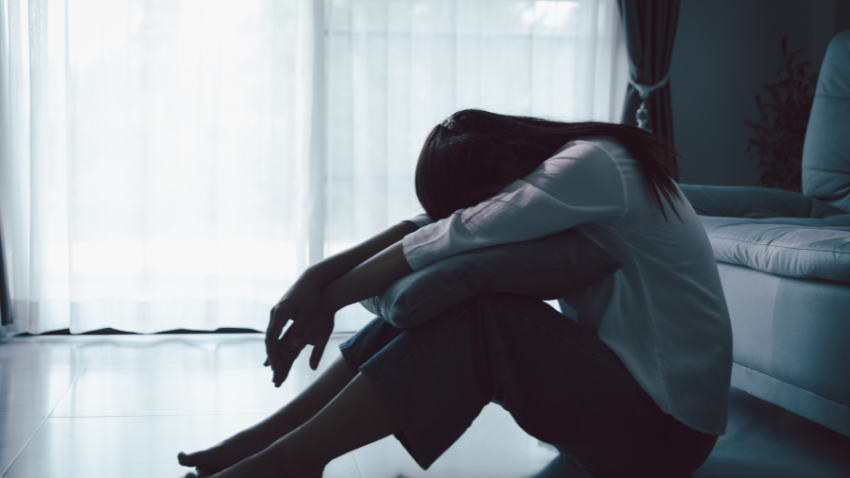a woman slumped down, feeling the tired effects of depression.